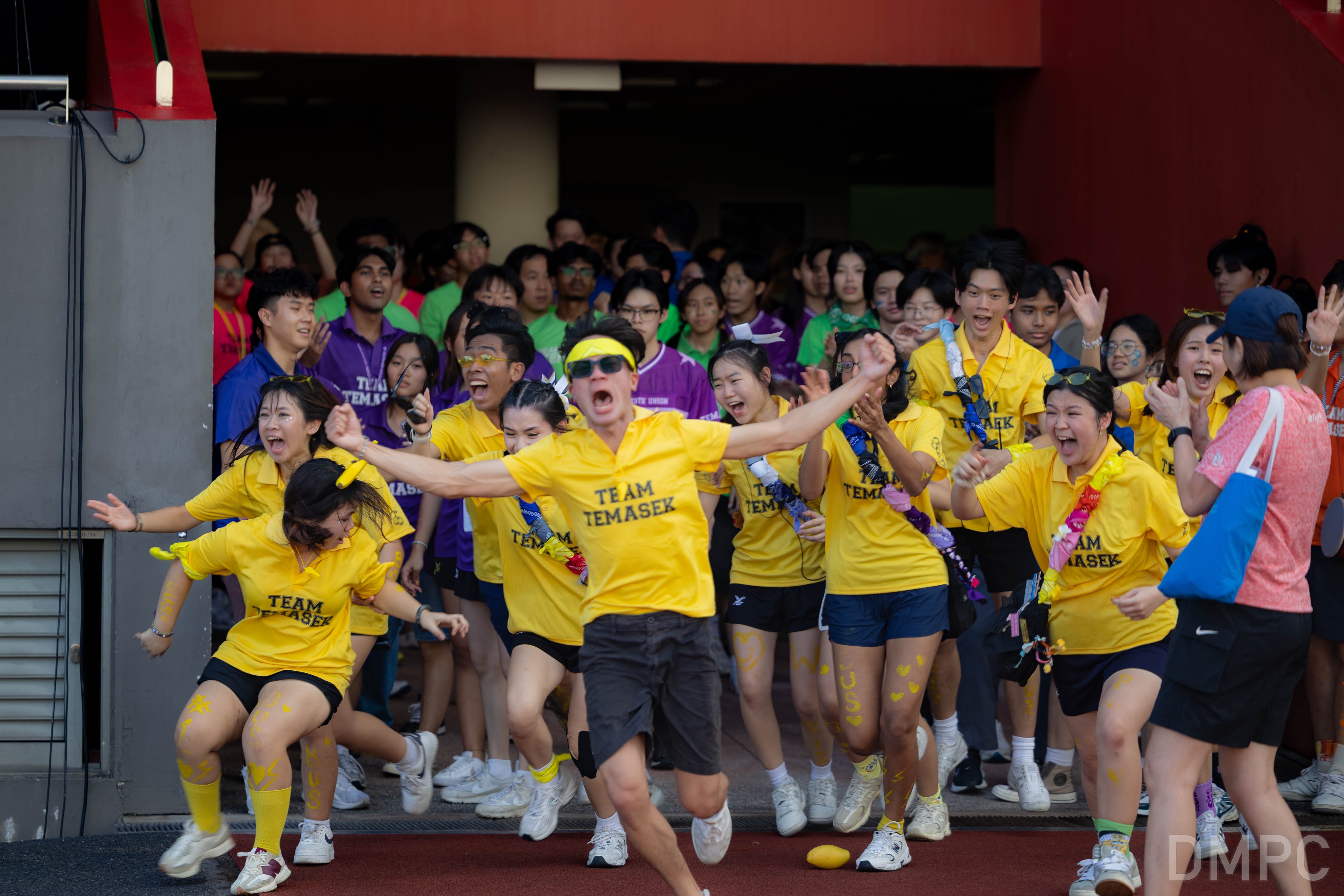 Image of students from different schools in TP cheering together